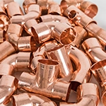 A pile of various different copper fittings